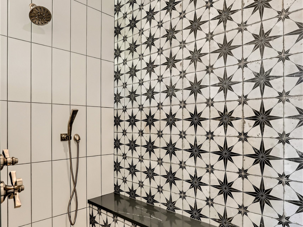 Black and white tile in a walk-in shower with bench